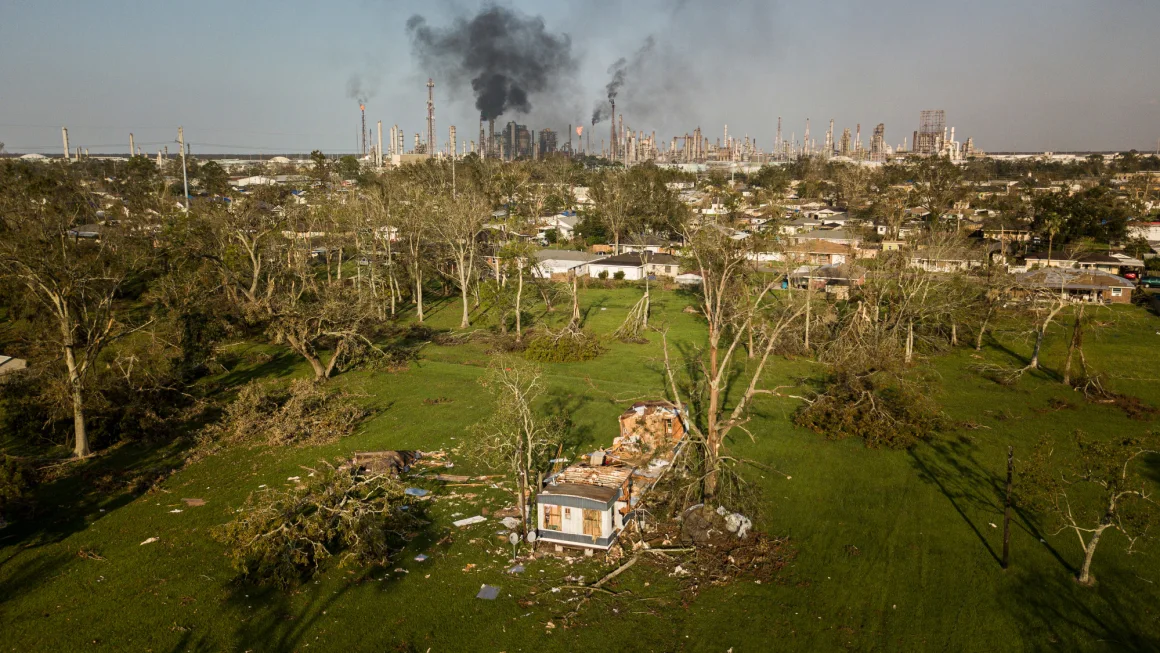 Damage from Hurricane Ida is seen in Norco, Louisiana, as smoke billows from an oil refinery in the distance