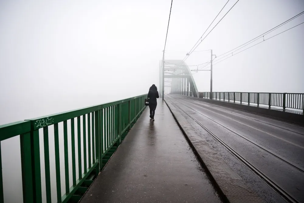 A pedestrian walks over a bridge in Belgrade as heavy fog and air pollution dominate the sky over the Serbian capital Belgrade on Jan. 16, 2020.