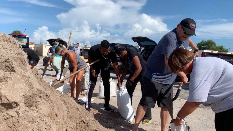Residents in Cocoa Beach, Florida, fill free sandbags handed out by the city on Friday, Aug. 19, 2019, in preparation for any impacts from Hurricane Dorian.