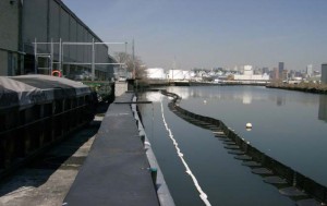 Containment boom located creekside of Peerless Importers