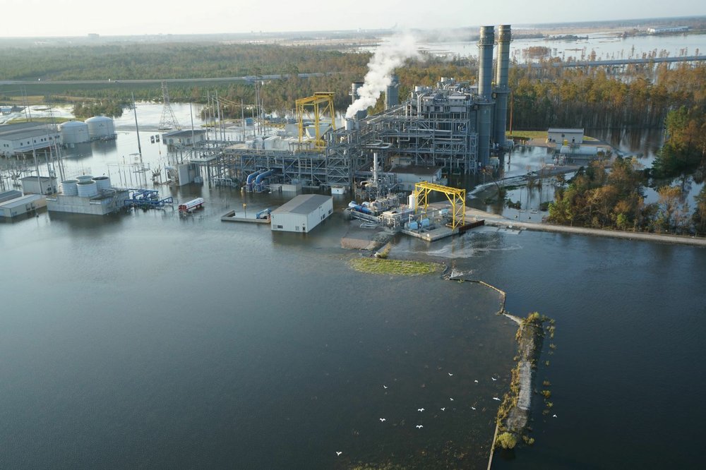 In this Sept. 21, 2018, photo released by Duke Energy, the L.V. Sutton Plant near Wilmington, N.C., is inundated by flood waters from the nearby Cape Fear River, triggering a shutdown and the evacuation of employees. Floodwaters also breached a dam at the electricity generating plant on Friday and overtopped a coal ash dump, potentially spilling toxic materials into the river.