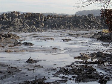 A 25-foot (7.6 m) wall of ash approximately 1 mile (1.6 km) from the retention pond