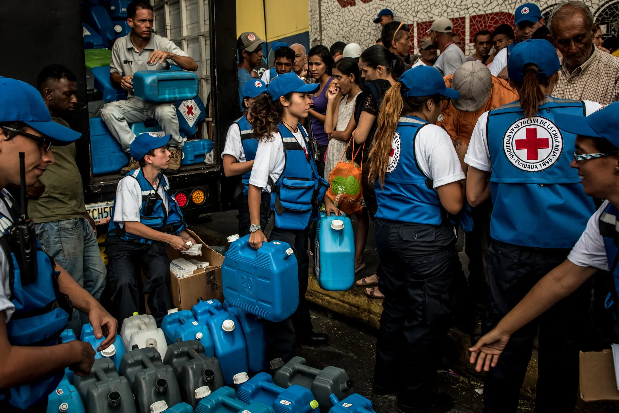 Red Cross workers handed out water containers and tablets to purify drinking water in Caracas.