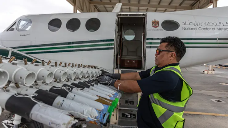 A ground engineer restocking one of the UAE’s National Center of Meteorology cloud-seeding planes with new Hygroscopic salt flares on January 31, 2024 in Al Ain, United Arab Emirates.