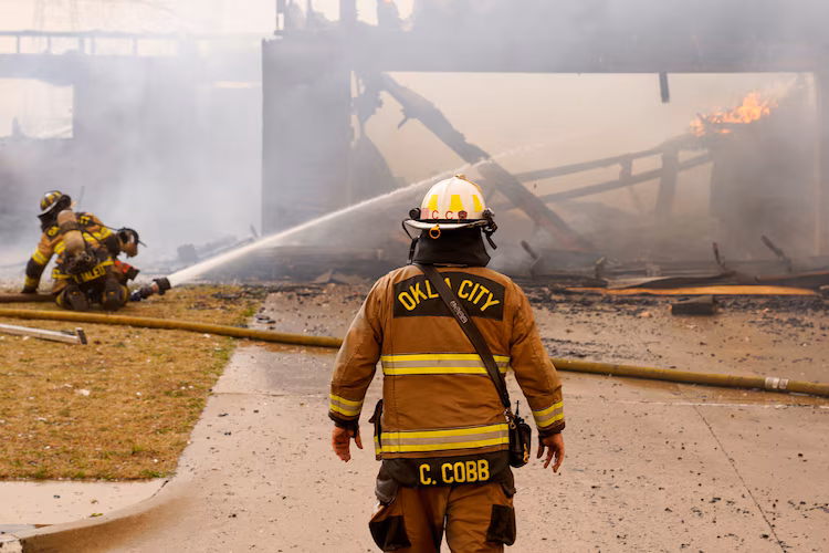 Firefighters battle a wildfire in Oklahoma City, March 14, 2025.