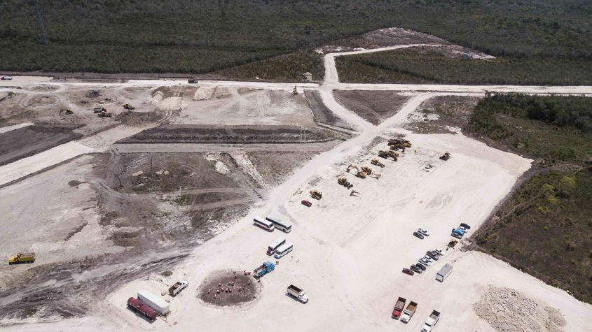 Military personnel building a train station in section 7, in Xpujil, Campeche.