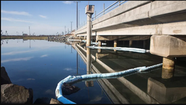 HAZMAT crews try to stop the spread of oil near the Talbert Channel in Huntington Beach on Sunday, October 3, 2021