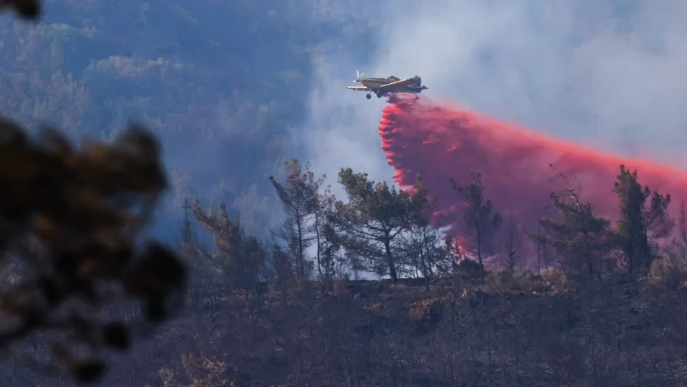 A plane responding to a wildfire in the Marmaris district of southern Turkey