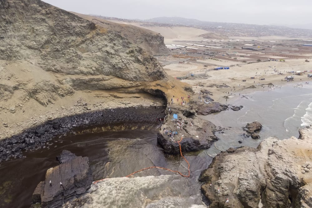 An aerial view of a contaminated cove in Ventanilla, where Repsol employees work on oil cleanup on January 20