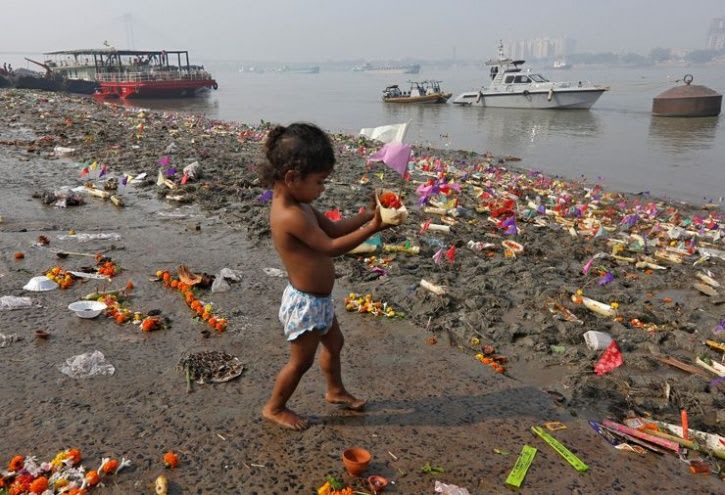 A child on the banks of the polluted Cooum River