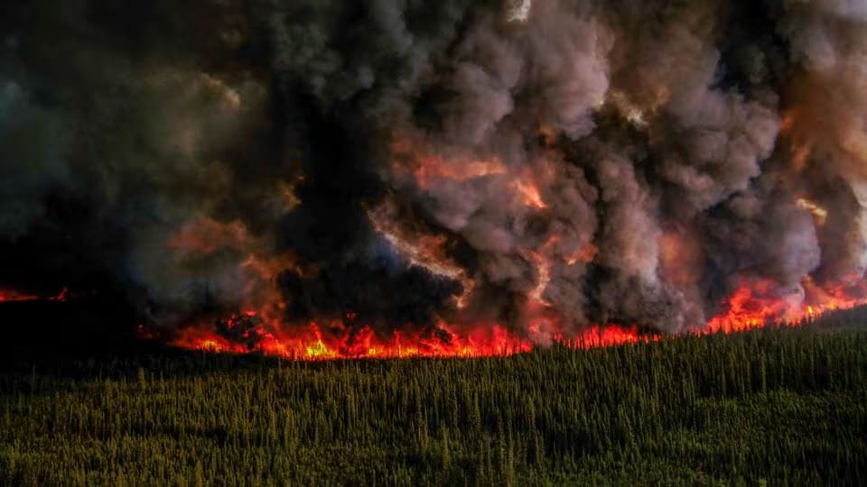 Smoke billows upwards from a planned ignition by firefighters tackling the Donnie Creek Complex wildfire south of Fort Nelson, British Columbia, Canada, June 3, 2023.