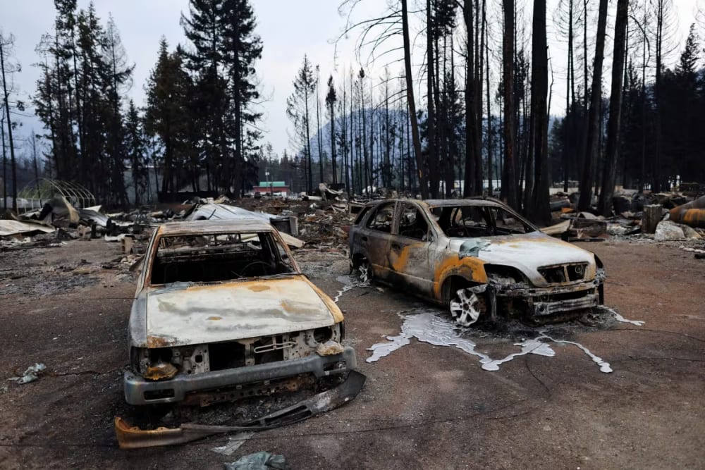 Burned vehicles are pictured Aug. 23 after the Bush Creek East wildfire destroyed dozens of homes in several rural communities including Scotch Creek, Lee Creek and Celista in the Shuswap region of B.C.