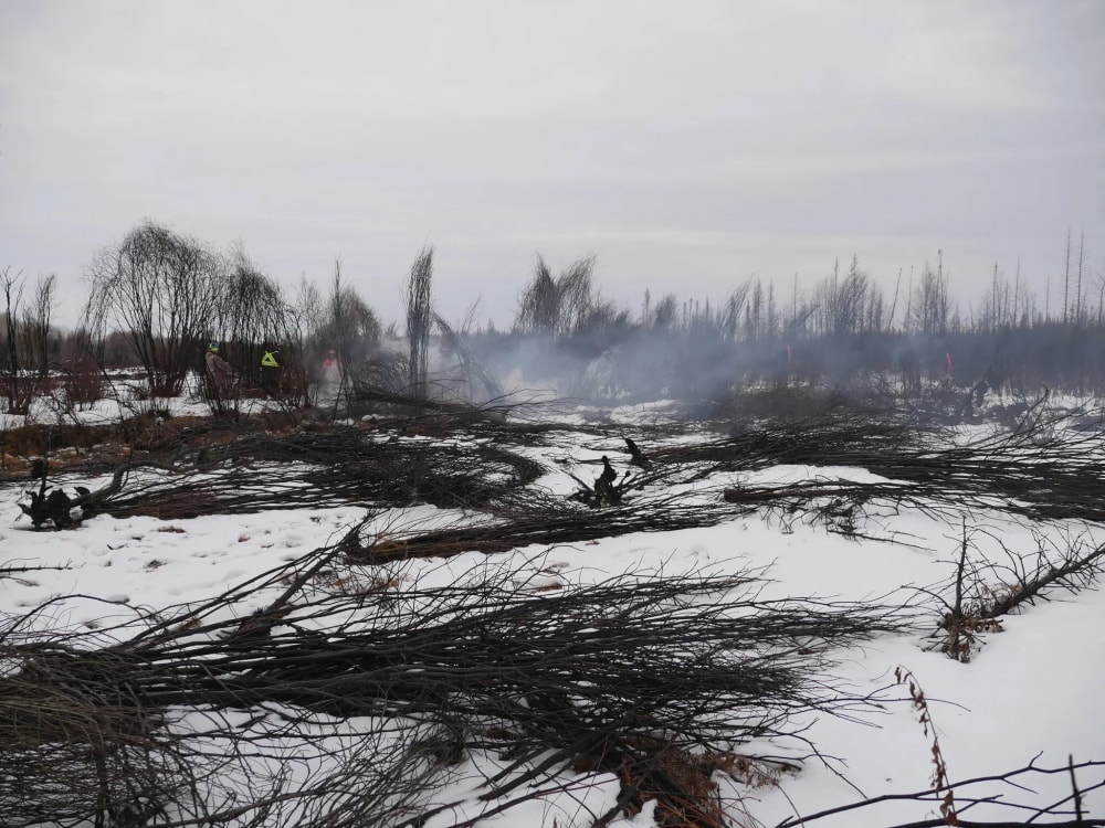This photo released by a Canadian fire department shows crews battling a fire last month that persisted despite the cold and snow in Alberta, Canada.
