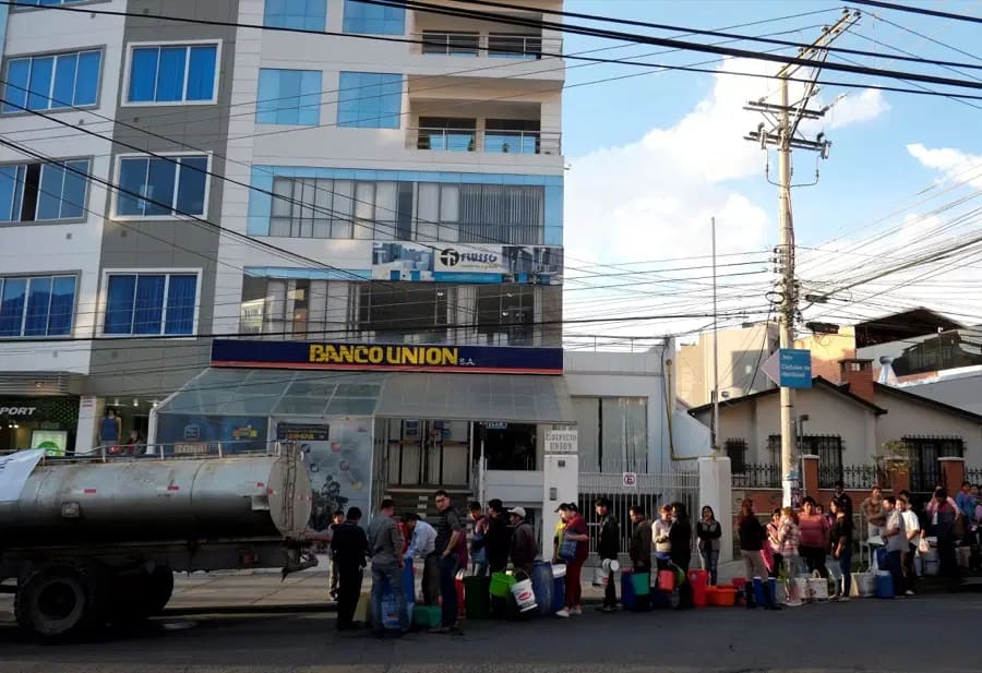 Bolivians stand in line to collect water from a truck in La Paz.