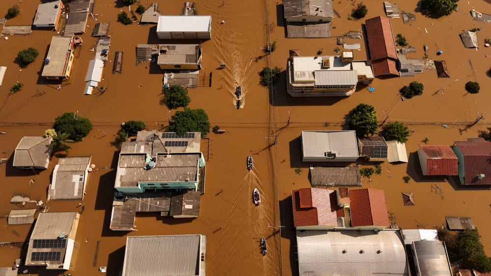 A drone view shows boats with volunteers searching for people isolated at houses at the flooded neighborhood of Mathias Velho in Canoas.