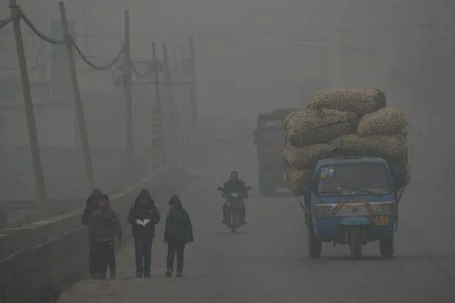 Children walk home after school on a severely polluted day in Shijiazhuang, China.