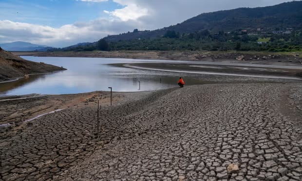 A worker monitors the water level of a reservoir on the outskirts of Bogotá on 8 April 2024.
