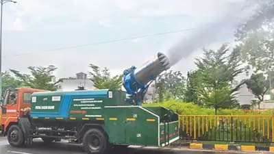 A truck-mounted anti-smog gun sprinkles water on a road in Patna.