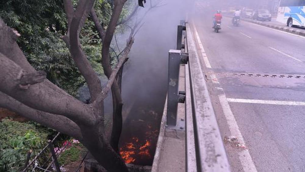 Garbage being burnt in the open, near a major flyover, in Bengaluru.