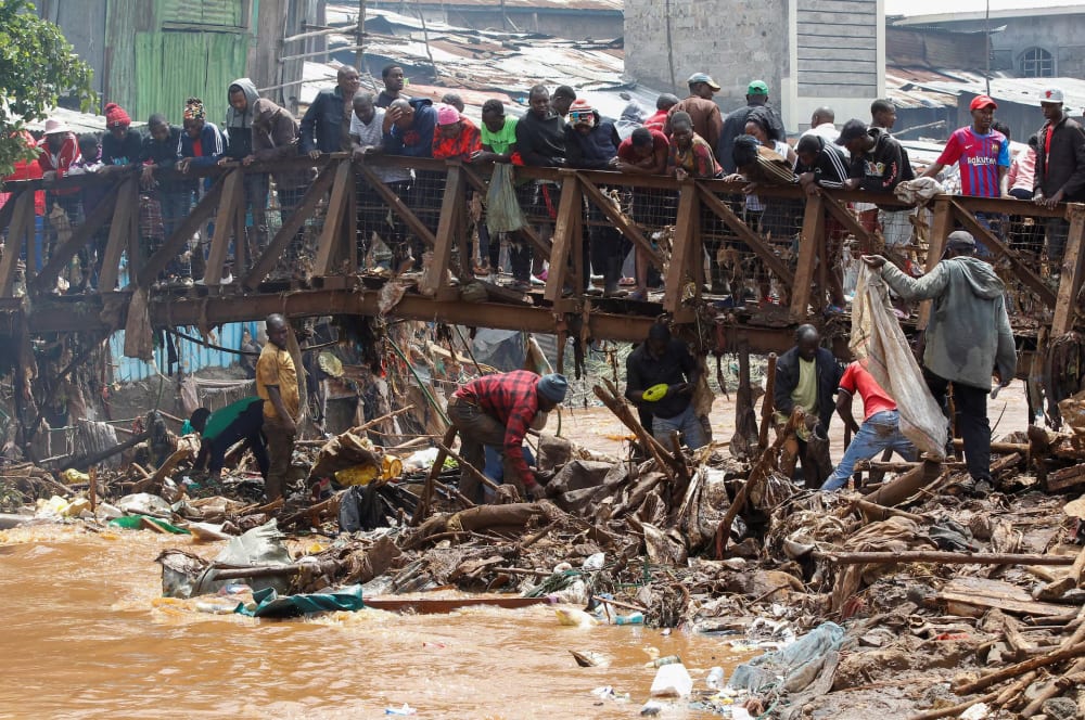 Residents sift through the rubble as they recover their belongings after the Nairobi river burst its banks and destroyed their homes within the Mathare Valley settlement in Nairobi, Kenya April 25. REUTERS/Monicah Mwangi