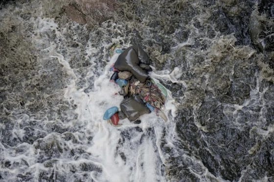 Trash sits in the Bagmati River as it flows in Kathmandu, Nepal.