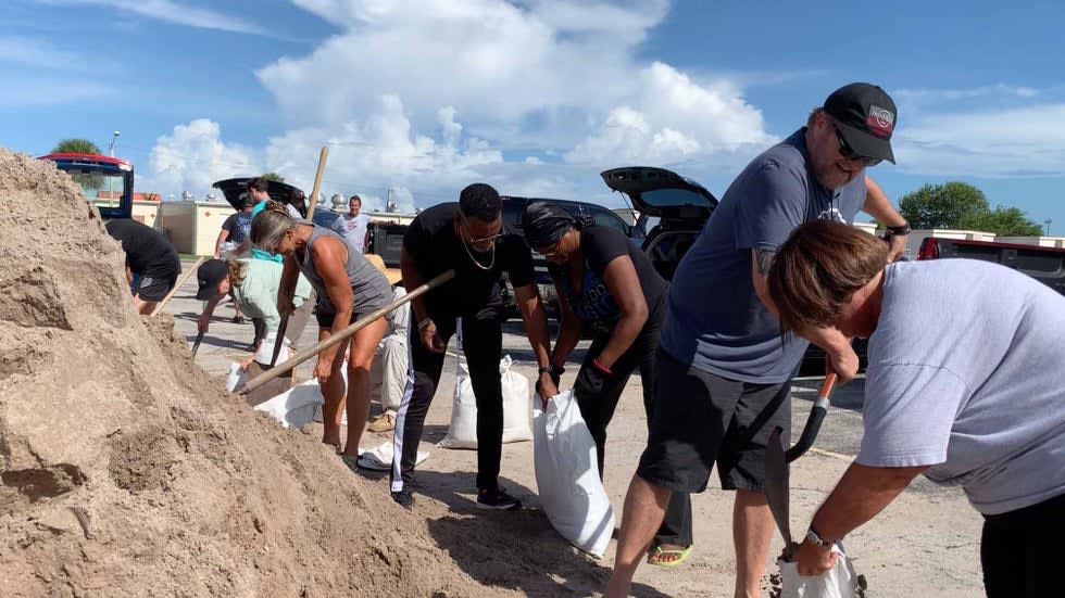Residents in Cocoa Beach, Florida, fill free sandbags handed out by the city on Friday, Aug. 19, 2019, in preparation for any impacts from Hurricane Dorian.