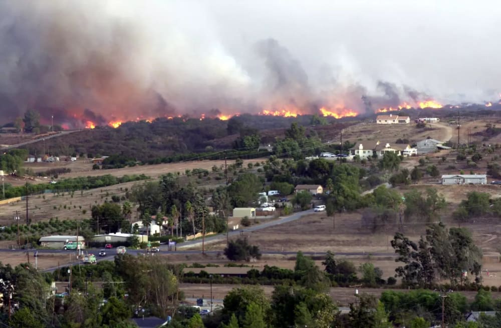 The Paradise fire burns just north of Valley Center Road west of Lake Wohlford Road on Oct. 26, 2003.