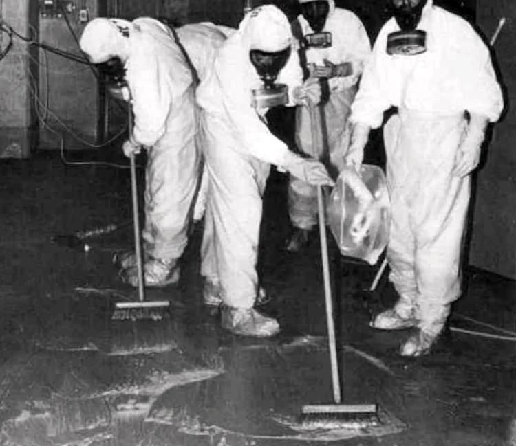 Three Mile Island personnel clean up radioactive contamination in the auxiliary building. 1979.
