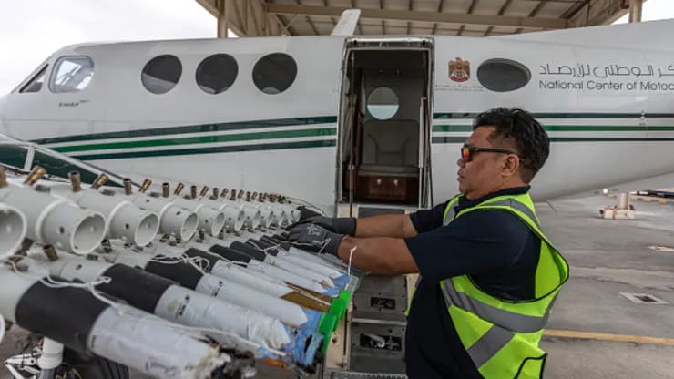 A ground engineer restocking one of the UAE’s National Center of Meteorology cloud-seeding planes with new Hygroscopic salt flares on January 31, 2024 in Al Ain, United Arab Emirates.