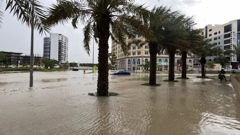 A person rides a motorcycle near a flooded street during a rain storm in Dubai, United Arab Emirates, April 16, 2024.