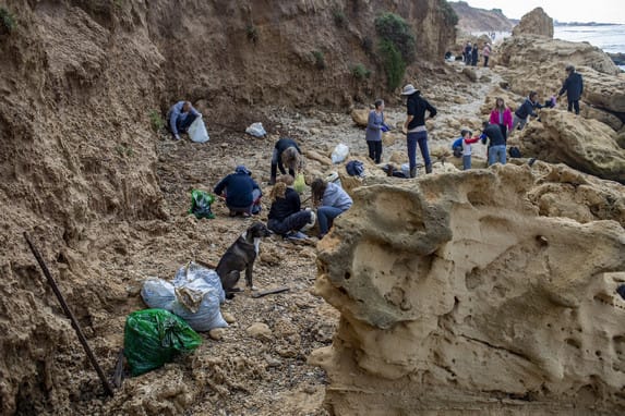 Volunteers gathered to remove clumps of sticky black