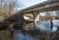 RAFT program volunteers sample and test water from Little Eagle Creek on Sunday, Dec. 12, 2021, on the west side of Indianapolis. The waterway connects to the White River