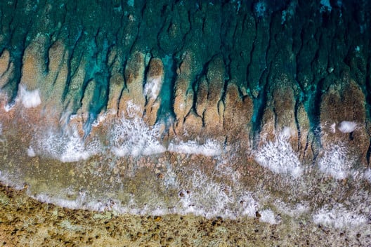Waves from the Pacific Ocean crash onto Funafuti’s shoreline