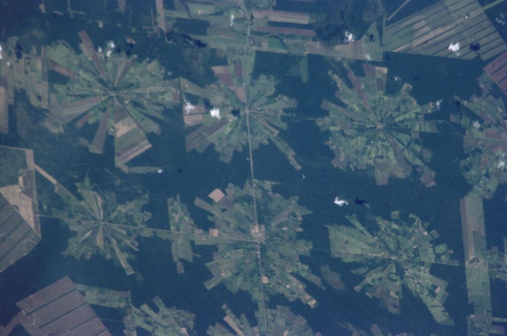 Astronaut photograph from the ISS showing the radial "pinwheel" pattern of agricultural settlements from the Tierras Bajas resettlement project east of Santa Cruz, Bolivia (2001)