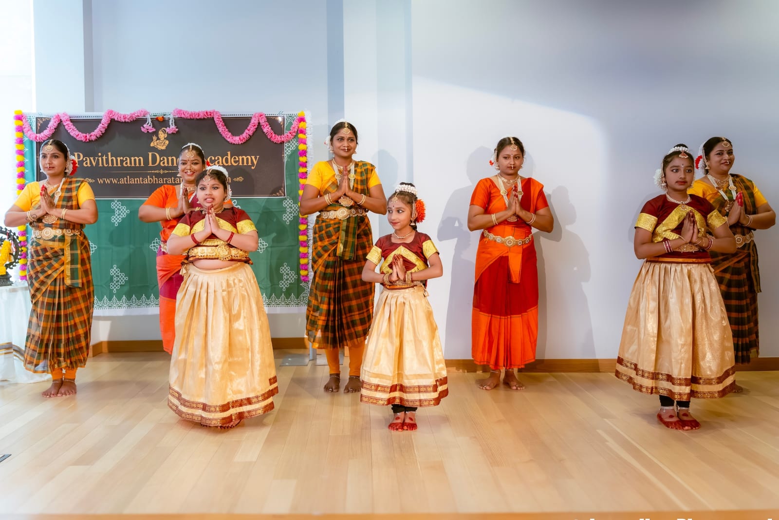 Indian dance students performing classical Bharatanatyam at academy recital