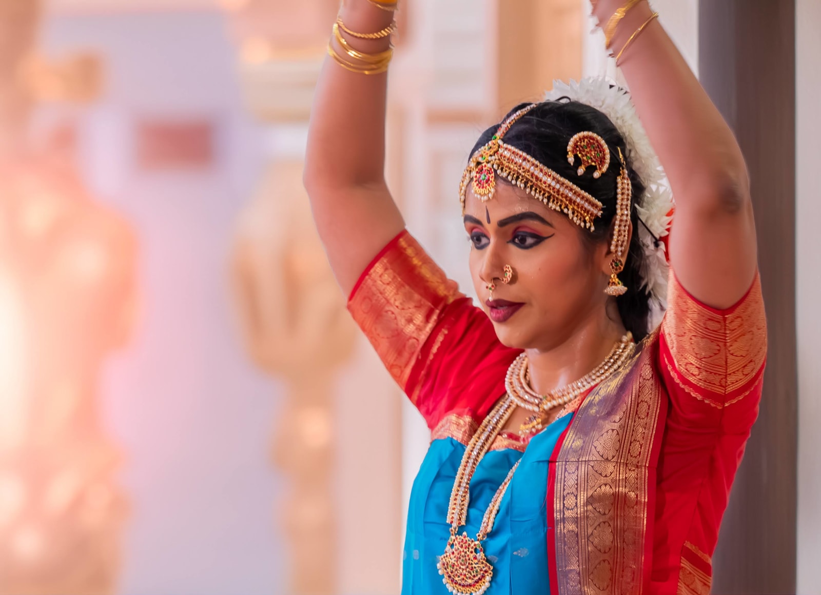 Classical Indian dancer in traditional costume with ornate jewelry and makeup