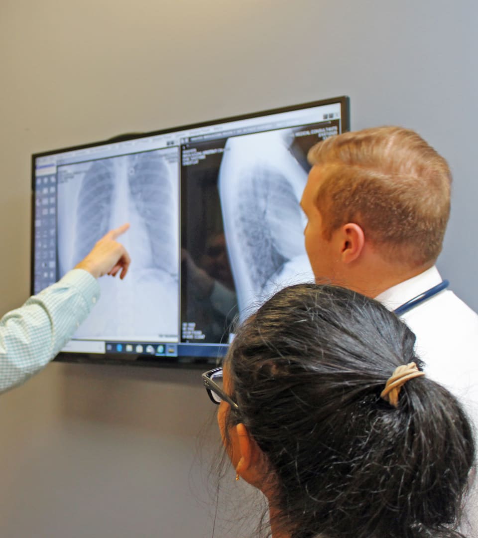Clinical exam scene with Dr. Pike reviewing patient imaging