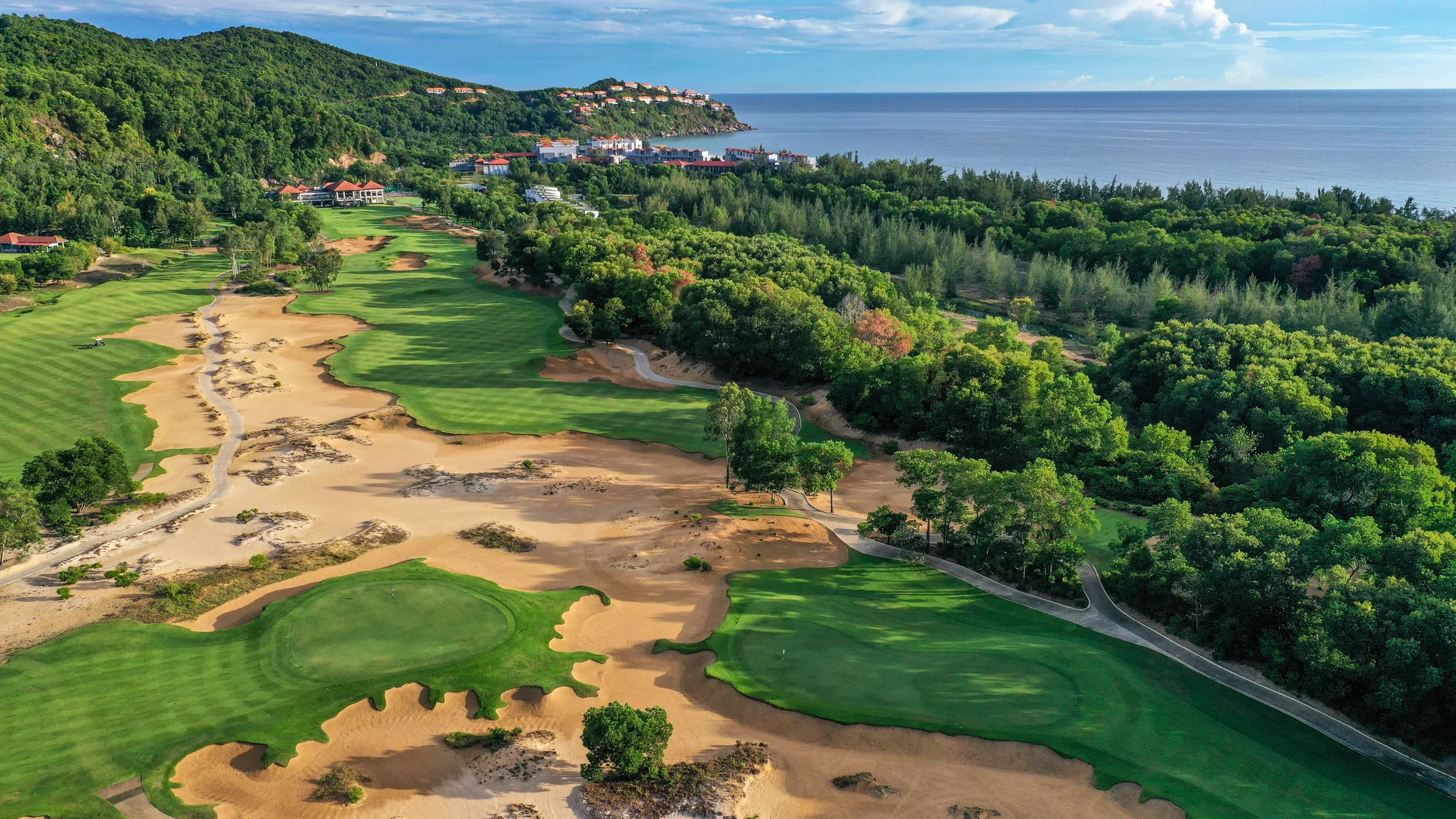 Laguna Golf Lang Co aerial view — championship course set between rice paddies and the East Sea
