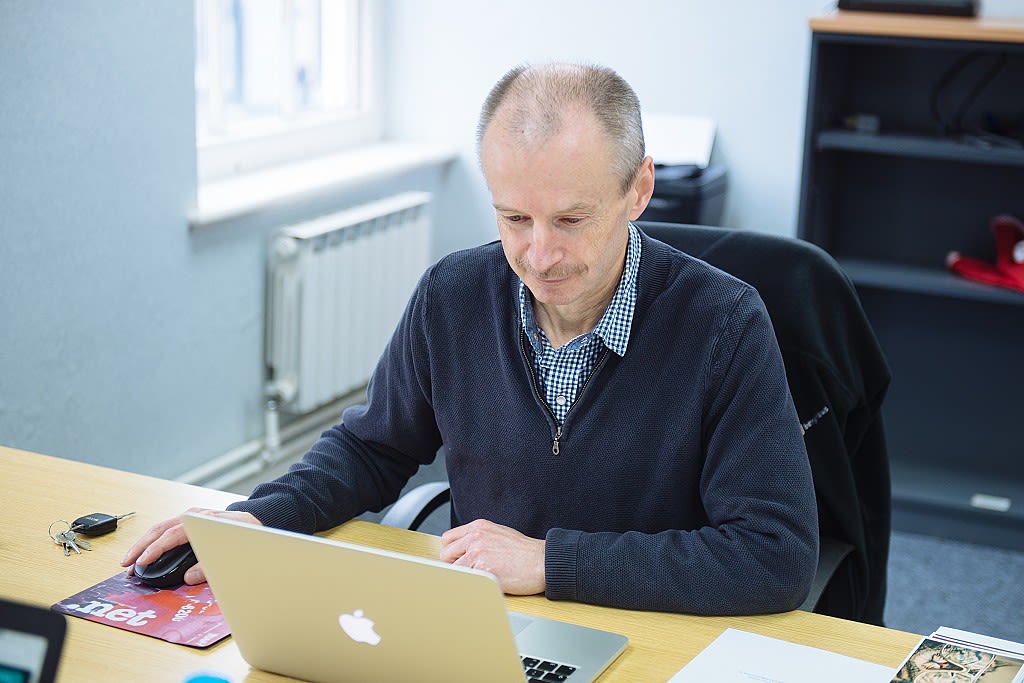 Clive Walker working at a desk