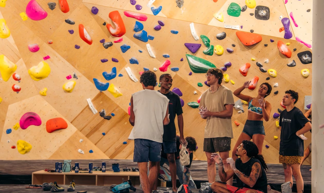 Climbers gathered at the base of the bouldering wall at Las Rocas