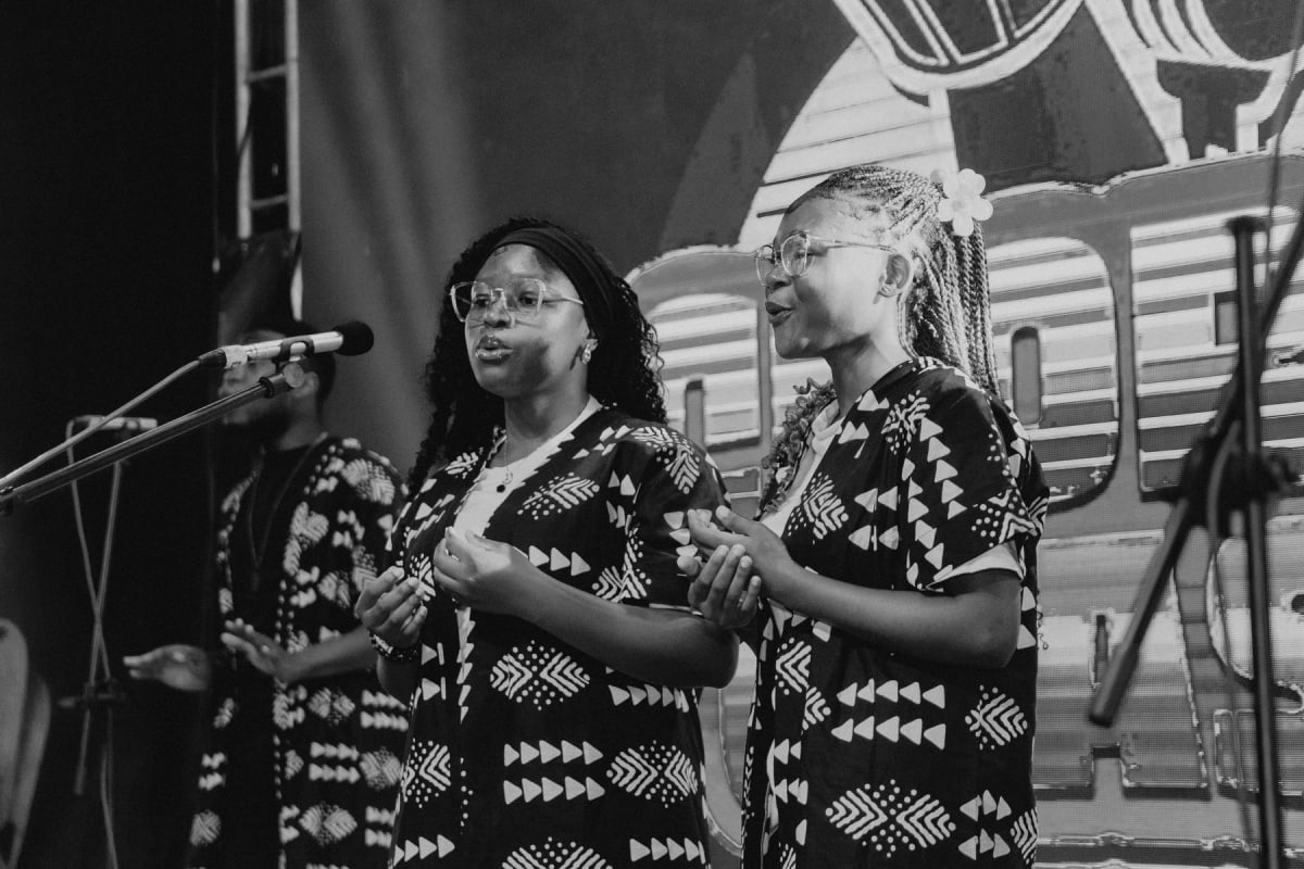 Two choir members singing in harmony