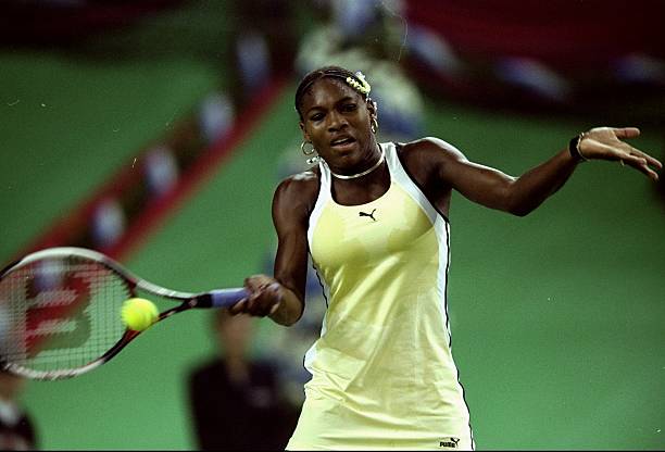 Serena Williams at Grand Slam Cup 1999 Final — white, black, and yellow Puma outfit