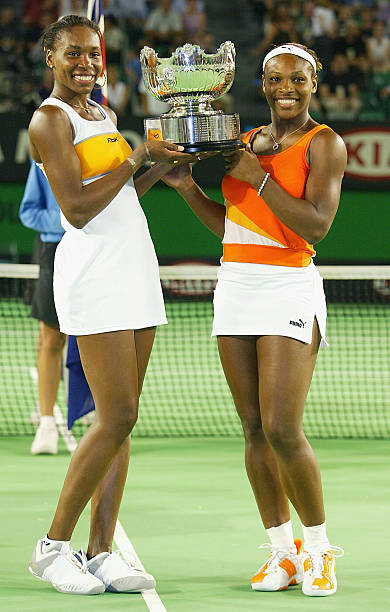 Serena Williams at Australian Open 2003 Doubles Final — white and orange Puma outfit