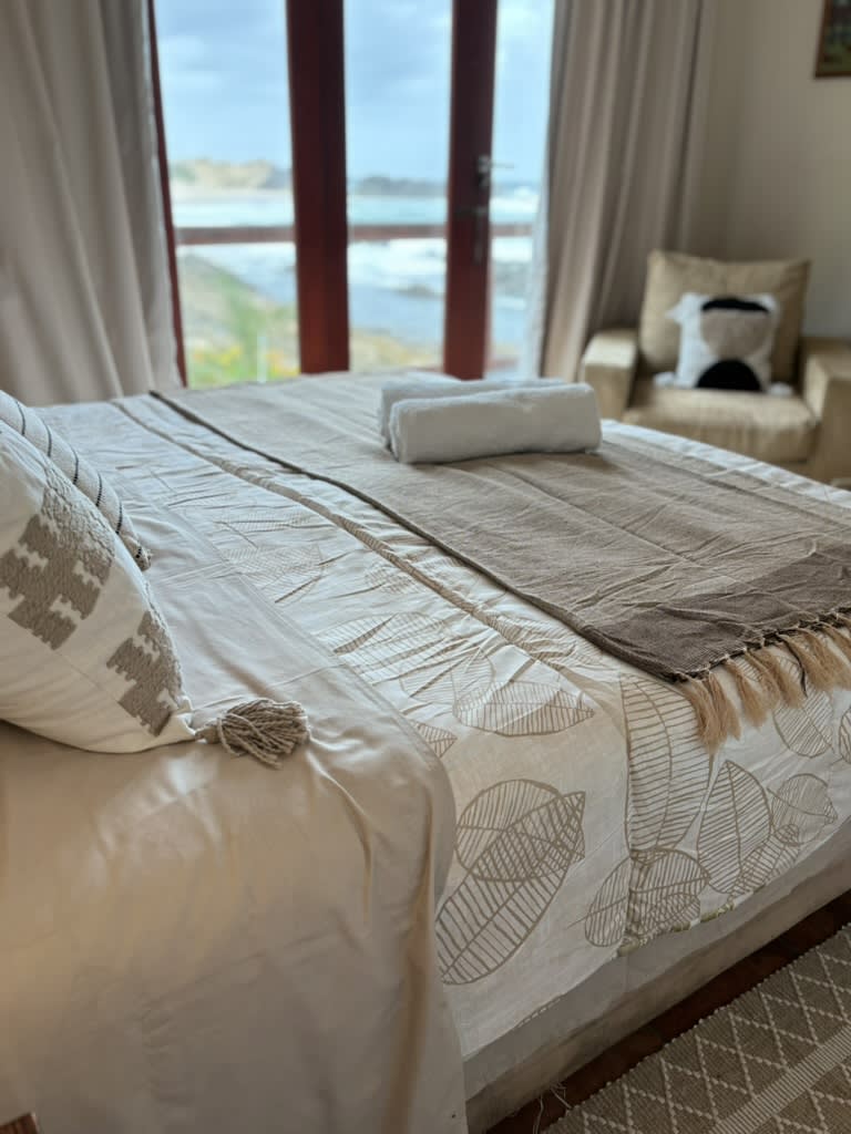 Panoramic Indian Ocean sunrise view from The Sunrise Room bed