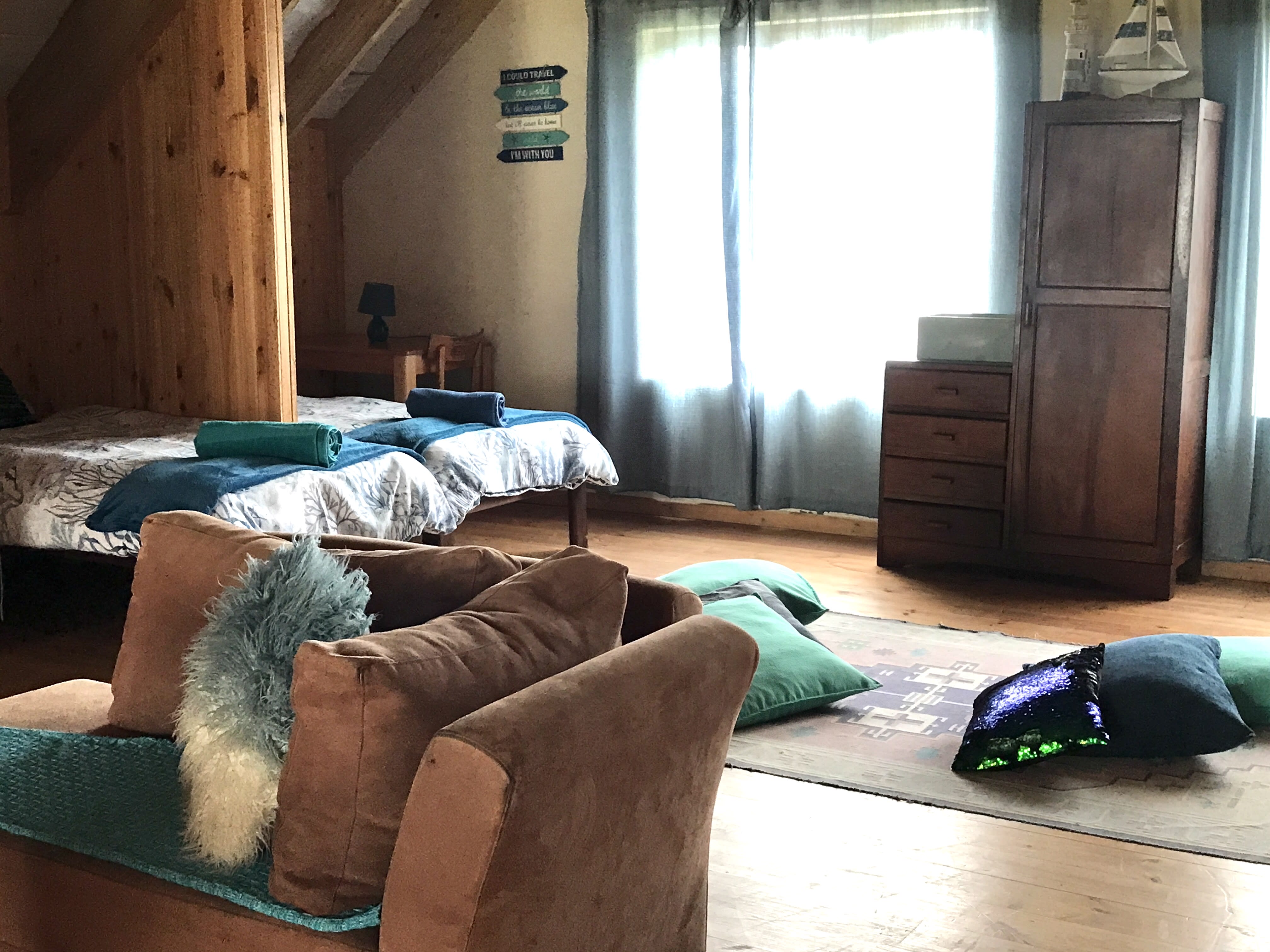 Cozy reading nook in The Loft, wooden chalet-style room at On The Rocks Villa