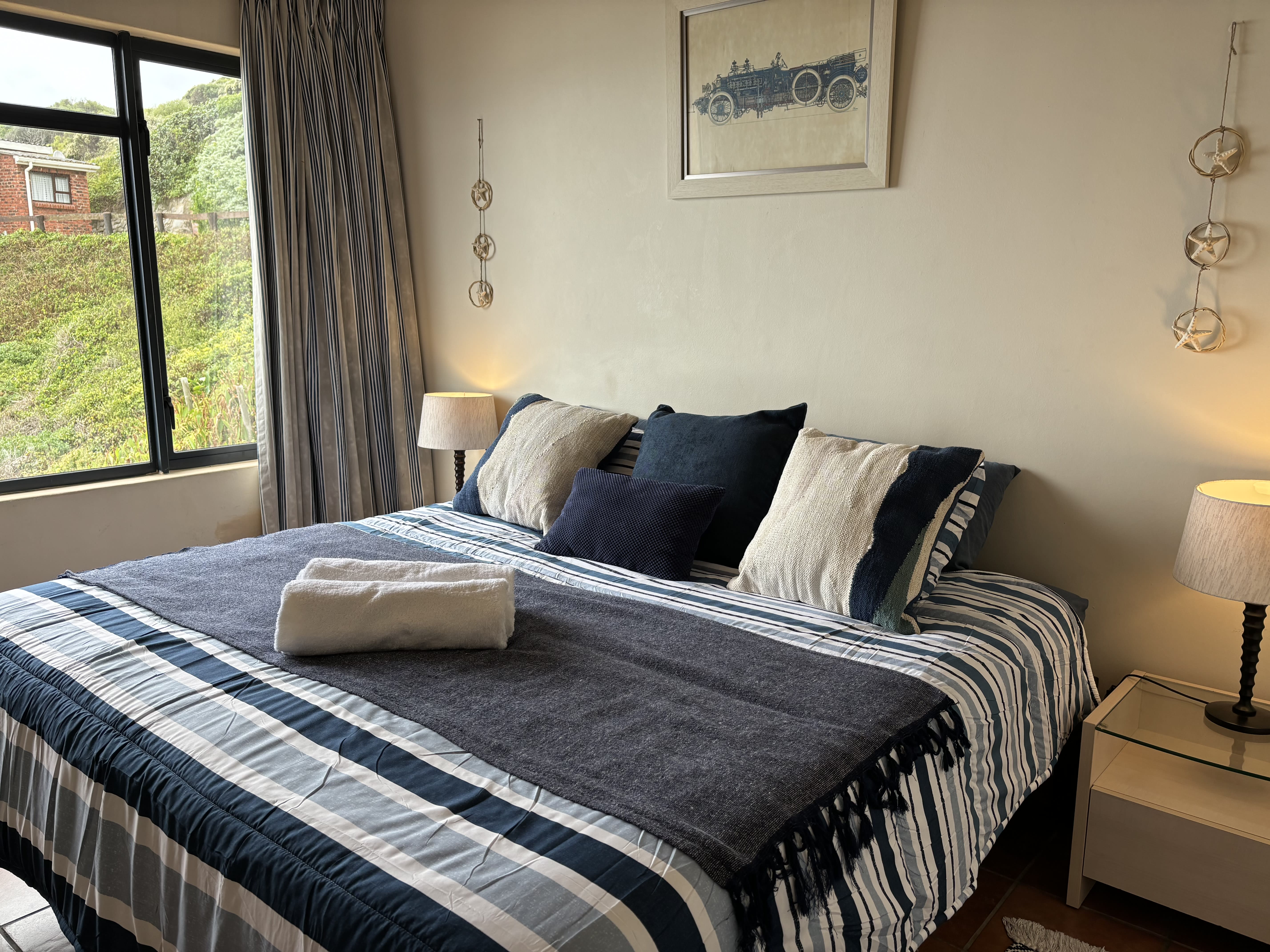 King-size bed in The Garden Room, On The Rocks Villa beach house