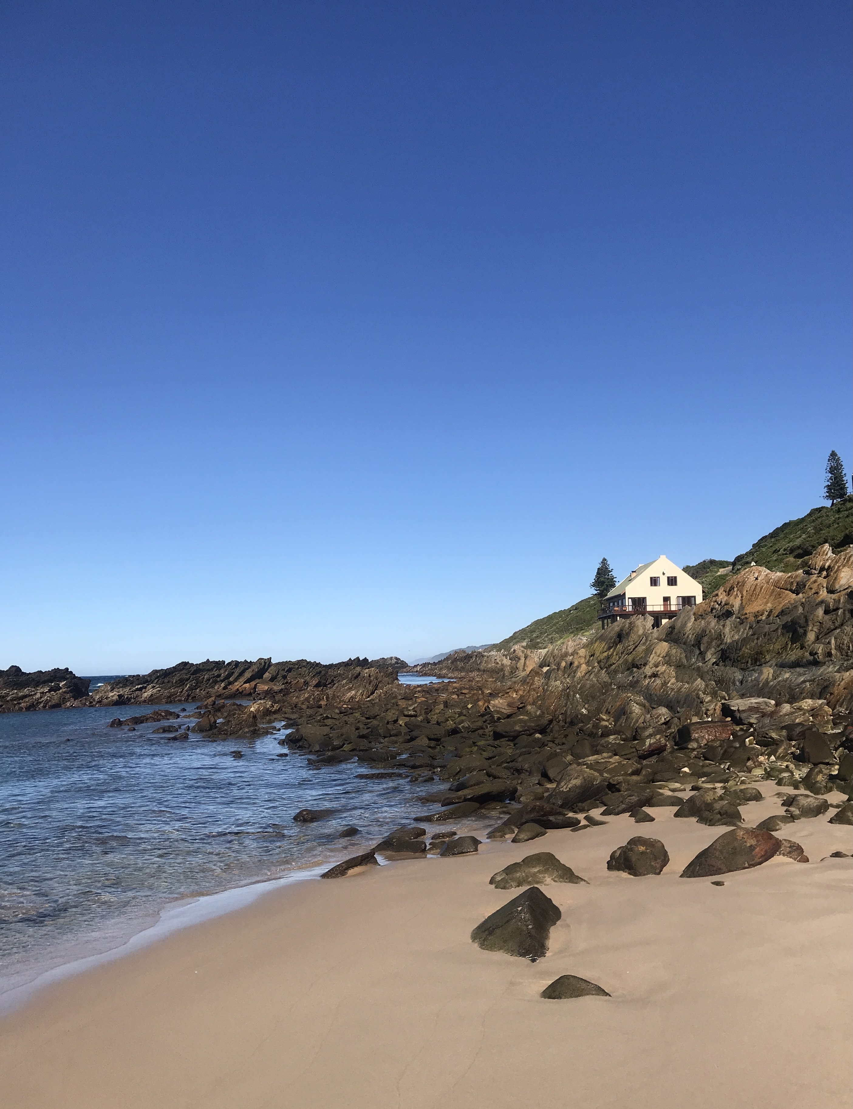 Wrap-around wooden terrace at On The Rocks Villa overlooking the ocean
