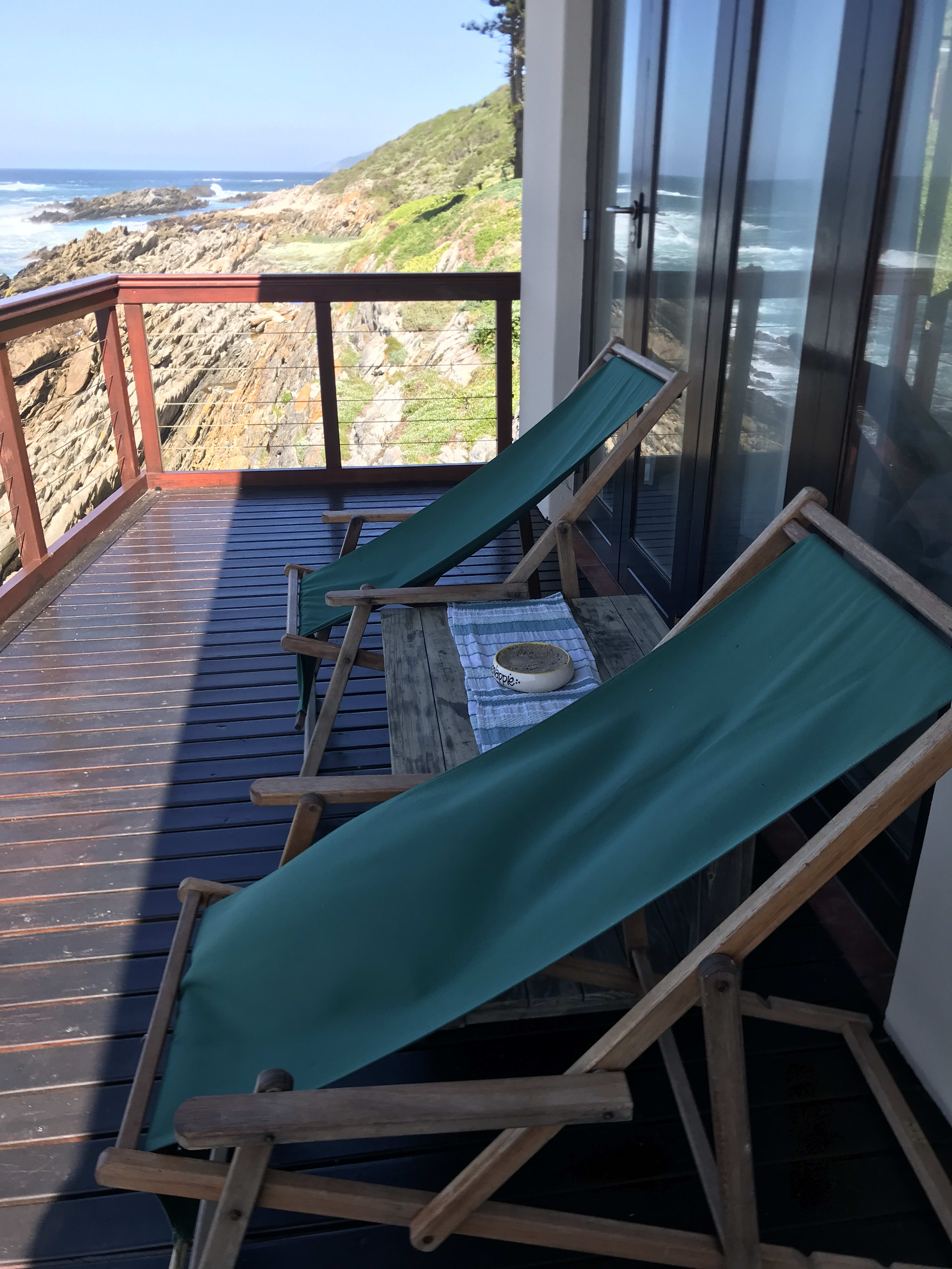 Outdoor entertaining deck at On The Rocks Villa with ocean backdrop