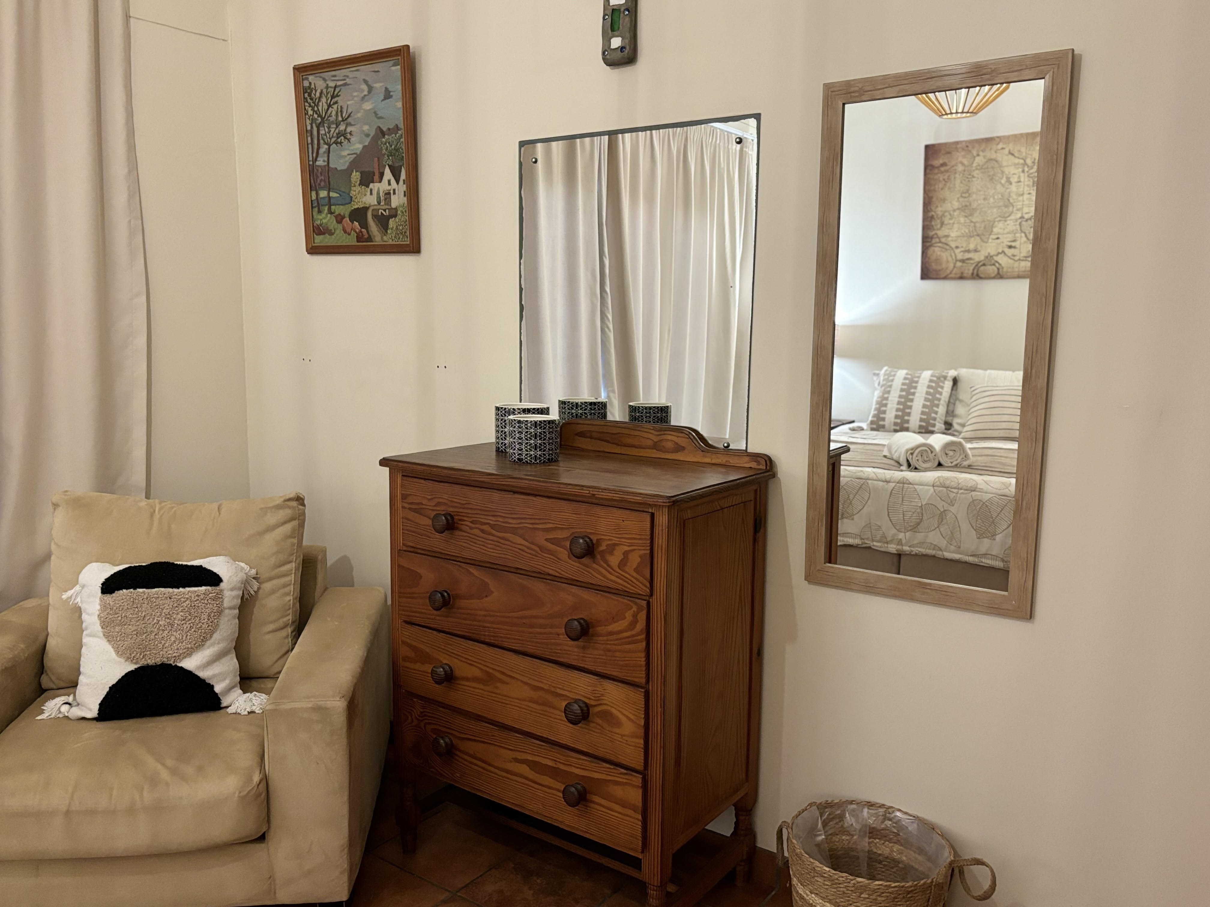 Full-length mirror and dresser in The Sunrise Room beach house bedroom