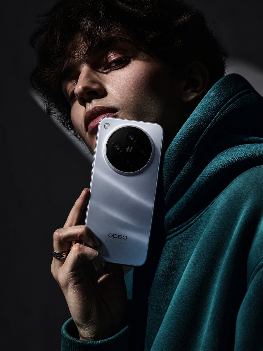 A high-fashion advertisement poster featuring a young woman holding an OPPO Find X9 Ultra smartphone over one eye against a deep teal background with cinematic lighting and luxury tech branding. Thumbnail 2